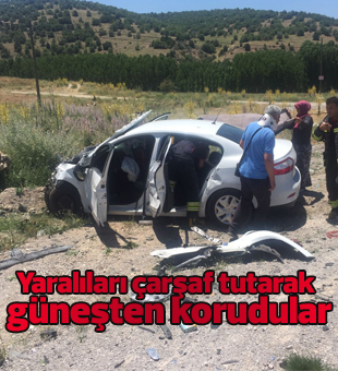 Yaralıları çarşaf tutarak güneşten korudular